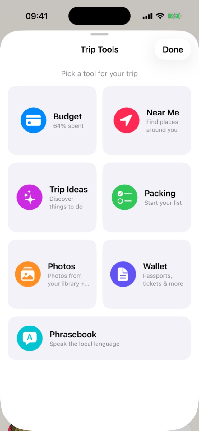 Trip Tools sheet with colourful round icons: Budget 64% spent, Near Me, Trip Ideas, Packing, Photos, Wallet and Phrasebook